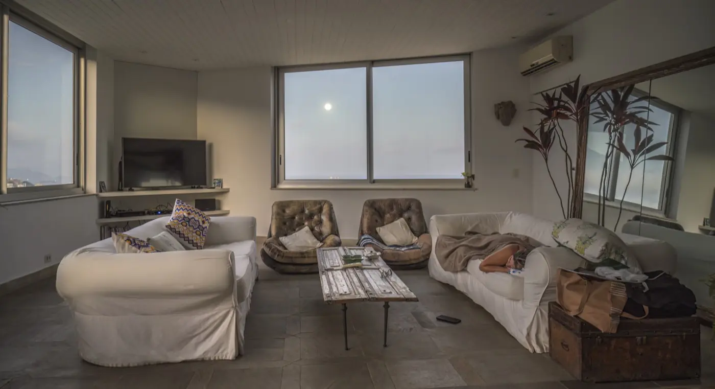 A bright modern living room with a sofa, armchairs and a coffee table in an apartment