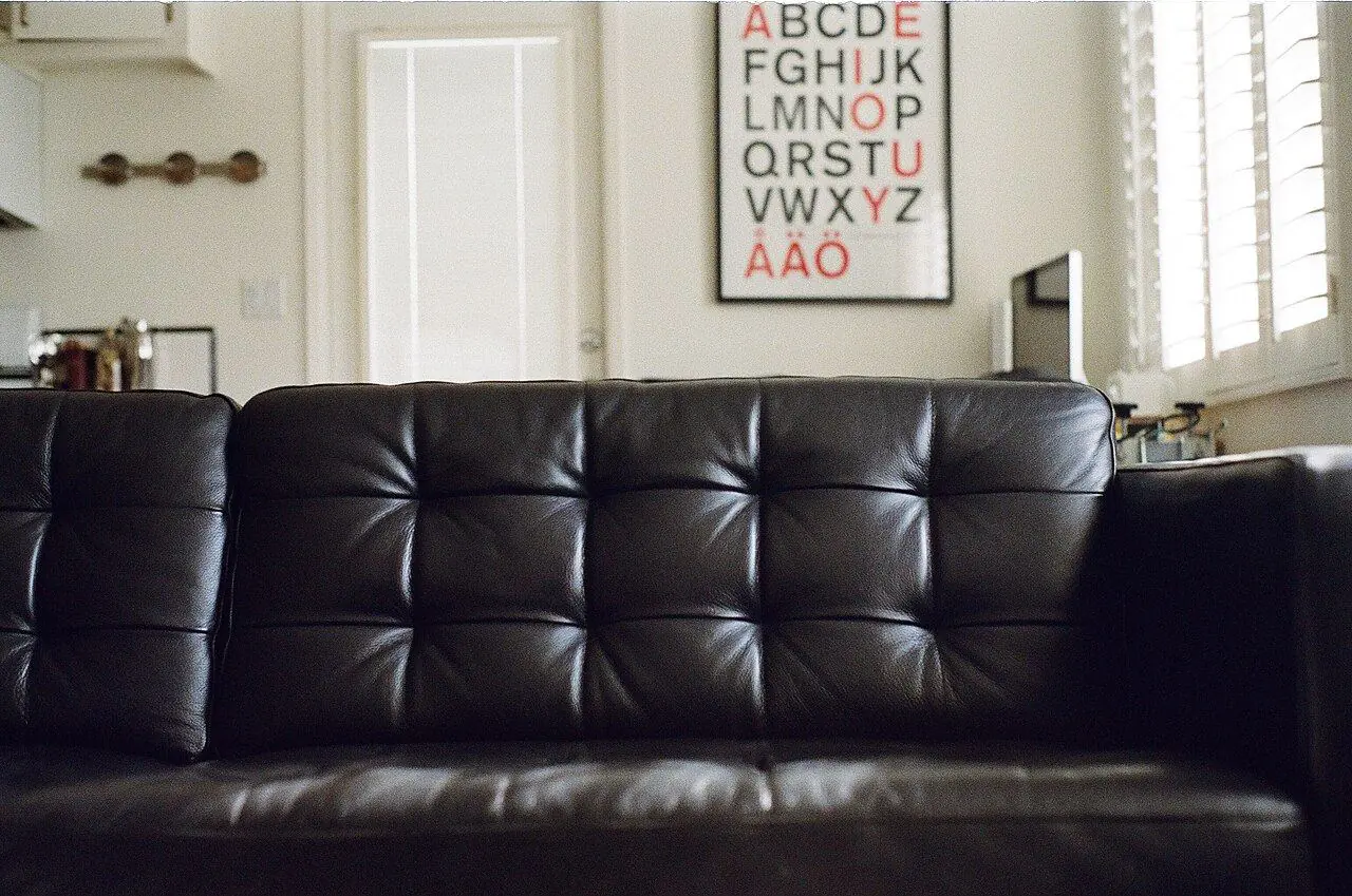 A beige fabric sofa against a light wall in a modern living room